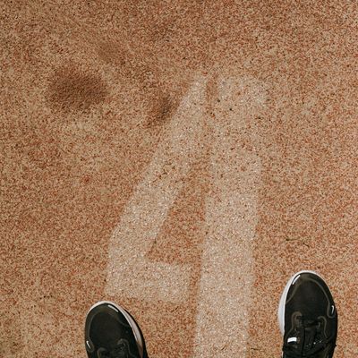 A person's feet in training shoes, firmly planted on the ground.